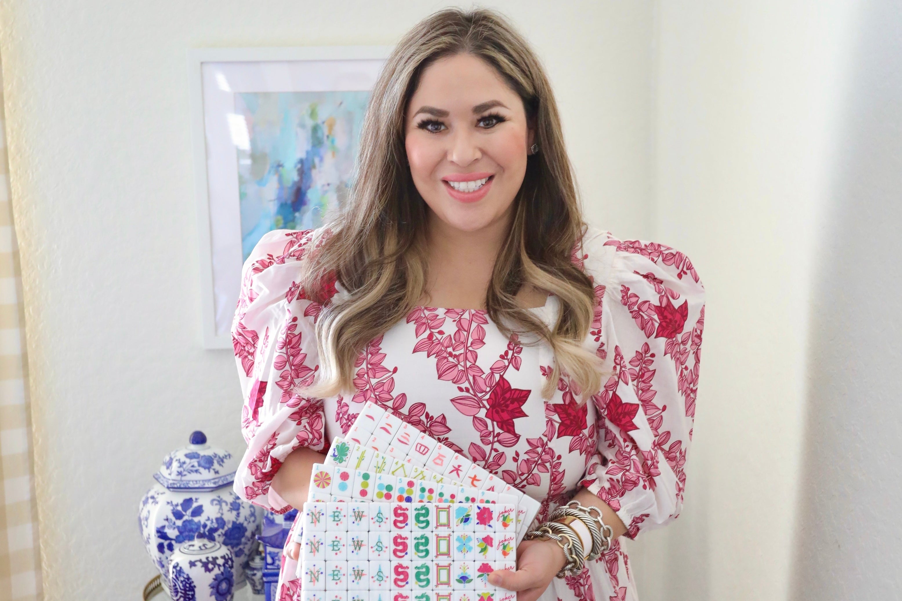 Kristel Powell, owner of Troop Mahjong, holding Oh My Mahjong  mahjong tiles